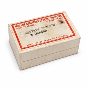 May include: A vintage aspirin tablet box from William Beaumont General Hospital in El Paso, Texas. The box is rectangular, with a red border and text that reads "ASPIRIN TABLETS 5 GRAINS" and "KEEP OUT OF REACH OF CHILDREN."