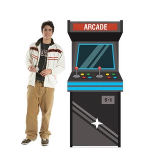 May include: A black arcade machine with the word "ARCADE" in red on top. The machine has a screen, joysticks, and buttons. A person wearing a white jacket and tan pants stands next to the machine.