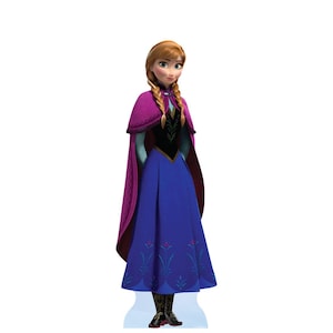 May include: A full-length cardboard cutout of a character with strawberry blonde hair in two braids, wearing a magenta cape over a black bodice with green accents, a long blue skirt with floral patterns at the hem, and black boots with gold details.