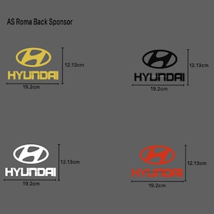 May include: Four Hyundai logo designs in gold, black, white, and red. Each logo includes the Hyundai wordmark and measures 19.2cm wide and 12.13cm tall. The logos are displayed on a gray background.