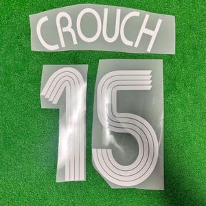 May include: White iron-on letters for a jersey, the name "CROUCH" and the number "15" in a retro font.