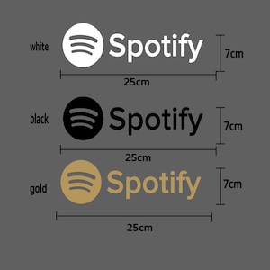 May include: Three versions of the Spotify logo, each with a different color: white, black, and gold. Each logo is 7 cm tall and 25 cm wide.