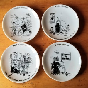 May include: Set of four white ceramic coasters featuring black and white illustrations of a cartoon character named Brother Juniper. Each coaster has a different illustration and a quote from the character. The quotes are: "Hand me my prayer book", "I keep telling myself there's no such thing as a bad boy", "I'll be all right in a minute. High prices always make me dizzy", and "Silence is Golden."