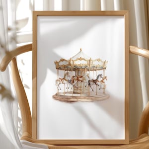 May include: A framed print of a carousel with detailed horses and ornate gold accents. The carousel is set against a white background, framed in a light wood. The image is displayed on a wooden chair.