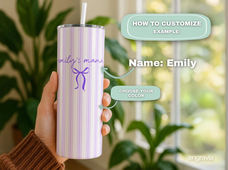 May include: A personalized tumbler with a white and lavender striped pattern. The tumbler features the text "emily's mama" in a script font, along with a purple bow graphic. It includes a white straw and a silver lid.