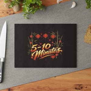 May include: A black cutting board with the text "5-10 Minutes" in gold and red script. The design includes red lanterns, bamboo stalks, and floral accents. The board is rectangular and sits on a wooden surface.