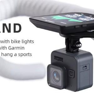May include: Black M5 stand for a bicycle, holding a sports camera and a cycling computer. The stand is mounted on white handlebars. The text "M5 STAND" is visible.