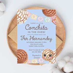 May include: Baby shower invitation with a light blue background, featuring concha bread illustrations and text that reads "There's a little Conchita in the oven!" and details for Fer Hernandez's baby shower.