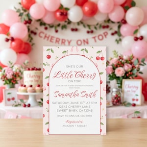 May include: A baby shower invitation with a cherry theme. The invitation features the text "She's Our Little Cherry On Top!" and details for the event. The background is a light pink with cherry illustrations. The invitation is surrounded by a festive cherry-themed party setup.