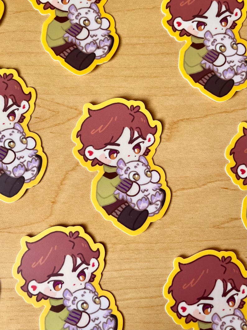 May include: A set of six stickers featuring a cartoon character with brown hair holding a white fluffy creature. The stickers are on a wooden surface.