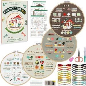 May include: An embroidery kit with a box featuring a mushroom design and the text "Embroidery Kit." The kit includes embroidery hoops with various stitch examples, needles, scissors, thread, and instructions. The hoops have the words "Easy," "Normal," and "Tough."