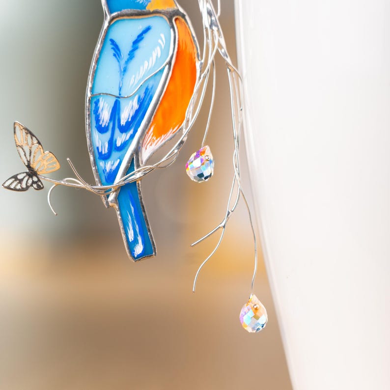 Shimmering stained glass bluebird with crystal-adorned butterflies – a breathtaking accent.
