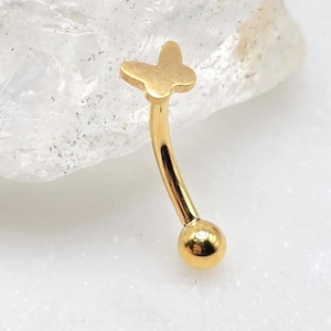 May include: Gold butterfly body jewelry with a ball end. The butterfly is a simple design with rounded edges.