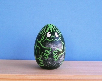 Bull frog Wakes up is a part of a series of solid wooden eggs.