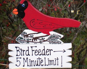 Yard Sign 150.1Cardinal Bird Feeder on a stake with painted pinecones and assorted berries.