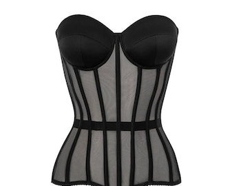 May include: A black strapless corset with a mesh panel and boning. The corset has a scalloped hem.