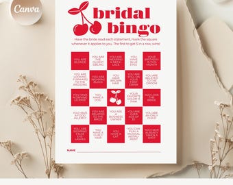 May include: A white bridal bingo game card with red text and cherry graphics. The card includes statements for guests to mark, with the text "bridal bingo" at the top. The bottom of the card reads "20 bridal shower games".