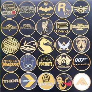 May include: A collection of 20 round, black and gold embroidered patches featuring various logos and designs. The patches include logos for popular video games, movies, and sports teams. Some of the logos include: Grand Theft Auto, Star Wars, Batman, Kingdom Hearts, Lara Croft Tomb Raider, L.F.C., Roland, World of Warcraft, Fortnite, 007 Goldeneye, Thor, and Star Trek.