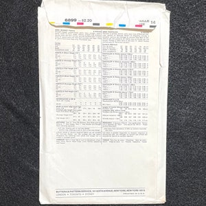 May include: A vintage sewing pattern for misses' pants, size 14, with instructions for different heights and measurements. The pattern is for straight-legged pants with pockets and a fly zipper. The pattern is printed on white paper with black text and includes a size chart and fabric suggestions.