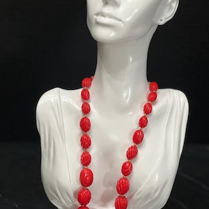 Vintage Red carved beaded necklace with gold bead accents.