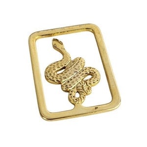 May include: A gold-colored metal bookmark featuring a detailed snake design within a rectangular frame. The snake is coiled and textured, with a raised head and scales. The frame has a polished finish.