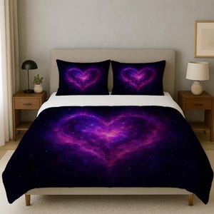May include: A bed set featuring a large heart design in shades of purple and pink against a dark blue background. The set includes a comforter and two pillowcases, all with a celestial nebula pattern. The bedding is on a bed with wooden nightstands.