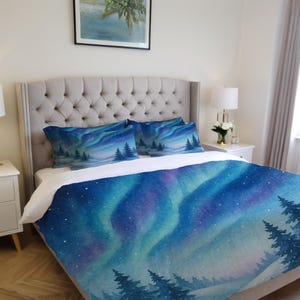 May include: A bed set with a watercolour design of the aurora borealis. The set includes a duvet cover and two pillowcases, displaying a vibrant array of blue, purple, and green hues with silhouetted trees.