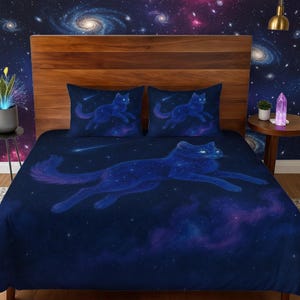 May include: A dark blue comforter set featuring a celestial wolf design. The wolf is depicted with a starry pattern, set against a backdrop of a galaxy with swirling nebulae and shooting stars. Includes two pillowcases with a similar design.