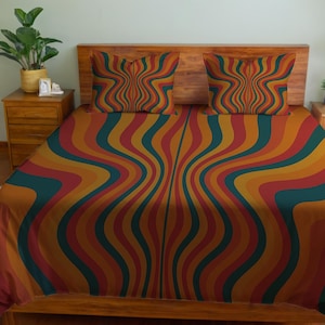 May include: A bed set featuring a vibrant, retro-style design. The bedding includes a duvet cover and two pillowcases, all adorned with a swirling pattern of orange, red, teal, and yellow stripes. The wooden headboard and nightstand provide a warm contrast to the colorful bedding.
