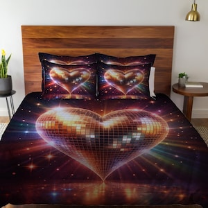 May include: Bedding set featuring a large heart-shaped disco ball design. The heart is composed of mirrored squares, reflecting light in shades of gold, orange, and purple. The background is a dark space scene with stars and colorful light bursts.