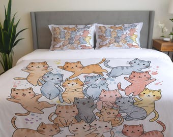 May include: White duvet cover with a colorful pattern of cartoon cats. The cats are in various poses, some are jumping, some are sitting, and some are standing. The background is white with colorful paint splatters.