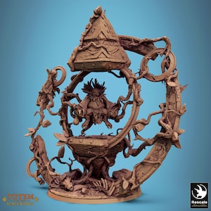 May include: A detailed brown sculpture of a fantastical creature within a circular frame of vines and leaves. The sculpture features a conical roof, a central figure with multiple limbs, and intricate details. The base has the text "TOTEM OF THE SCALEWINGS".