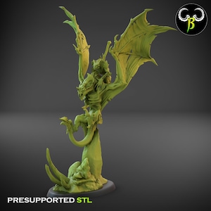 May include: A lime green dragon figurine with large wings and a rider. The dragon is perched on a rocky base. The text "PRESUPPORTED STL" is at the bottom. A logo is in the upper right corner.
