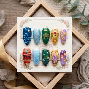 May include: A set of ten press-on nails with various designs, including waves, snowflakes, a lotus flower, a rose, and a sun. The nails are displayed on a card with floral accents, set in a wooden frame.