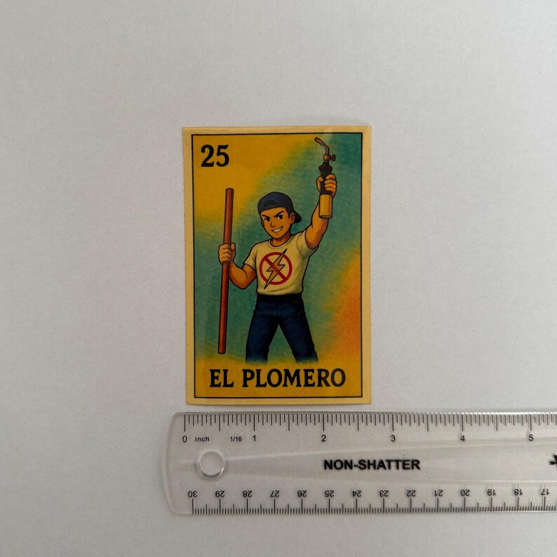 May include: A yellow and blue card with the number 25 and the text "EL PLOMERO" printed on it. The card features a cartoon illustration of a person wearing a blue shirt with a red lightning bolt symbol and blue jeans, holding a wrench and a blowtorch.