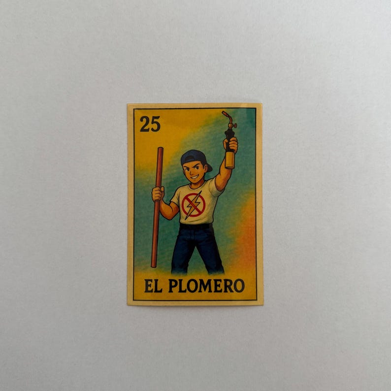 May include: A yellow and blue card with a cartoon illustration of a person holding a wrench and a blowtorch. The card has the number 25 and the text "EL PLOMERO" printed on it.