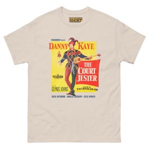 May include: A vintage movie poster for the film "The Court Jester" starring Danny Kaye. The poster features a colorful image of Danny Kaye dressed as a jester, holding a lute. The text on the poster reads "Paramount Presents Danny Kaye The Court Jester VistaVision Color by Technicolor Glynnis Johns Basil Rathbone Angela Lansbury Cecil Parker."