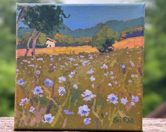 May include: A small painting on canvas depicting a field of purple wildflowers in the foreground, with a white house and trees in the background. The sky is blue and the hills are green. The painting is signed "Sri Rao" in the lower right corner.