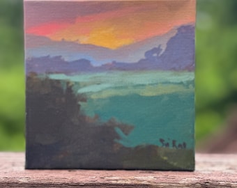 May include: A small painting of a sunset over a landscape with a teal lake and a dark green forest in the foreground. The artist's signature, "Sai Rat", is in the bottom right corner.