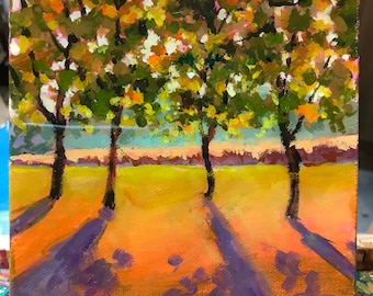 May include: A painting of three trees with green and yellow leaves in a field with long shadows. The sky is a light blue with a hint of orange. The painting is signed "Sri Rao" in the bottom right corner.
