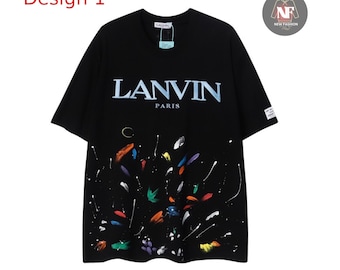 May include: Black t-shirt with the text "LANVIN PARIS" in white. The shirt features a colorful paint splatter design at the bottom. The words "Design 1" are in red at the top left corner.