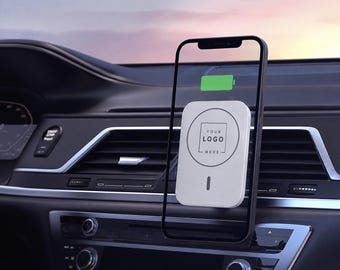 Peut inclure: Un chargeur sans fil magnétique rectangulaire blanc avec une zone de logo circulaire et un petit voyant vertical, fixé sur une grille d'aération de voiture. Le chargeur est fixé à un smartphone noir affichant une icône de batterie verte.