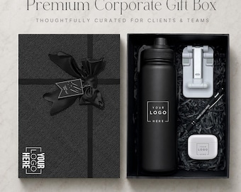 May include: A black gift box with a ribbon and tag, containing a matte black water bottle, a white foldable phone stand, a black pen, and a white earbud case. Each item features the text YOUR LOGO HERE, with the box lid also labeled.