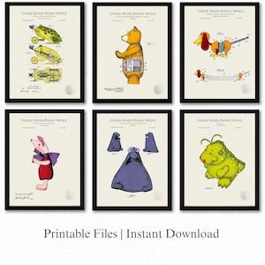 May include: Six framed patent prints featuring whimsical toy designs. The prints include a frog on wheels, a bear, a dachshund, a pig, a group of purple creatures, and a green monster. The text "Printable Files | Instant Download" is at the bottom.