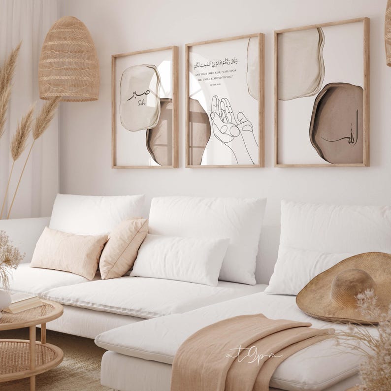 May include: Three framed prints with abstract shapes and Arabic calligraphy. The prints are in a living room setting with a white couch, pillows, and a throw blanket.