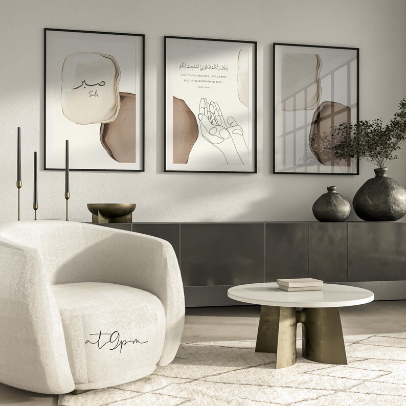May include: Three framed prints with abstract brown and beige watercolor designs. The center print features a line drawing of hands in prayer with Arabic text. The text reads "And your Lord said, "Call upon Me, and I will respond to you."