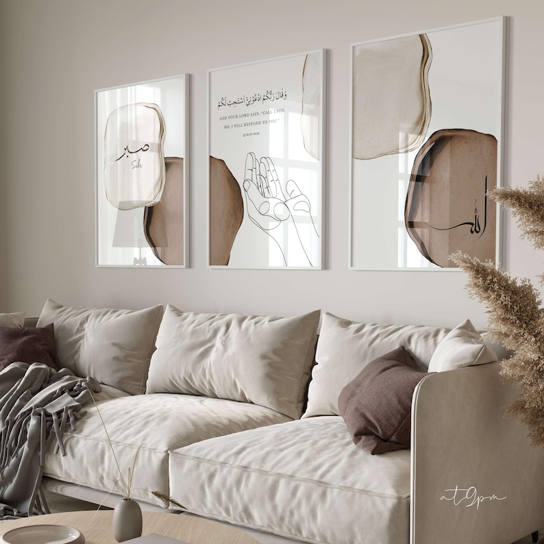 May include: Three framed prints with abstract brown watercolor shapes and Arabic calligraphy. The center print features the text "And your Lord said, "Call upon Me, and I will answer you." The left print features the word "Subh" in Arabic calligraphy. The right print features the word "Allah" in Arabic calligraphy.