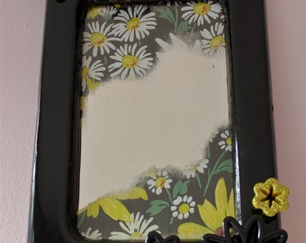 Small victorian inspired wall mirror with high gloss black frame embellished with black and yellow glitter flowers