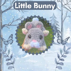 May include: A handmade gray crochet bunny with pink inner ears, a pink nose, and large black eyes. The bunny is lying down, with the text "Little Bunny" above it. The background features butterflies and a winter scene.