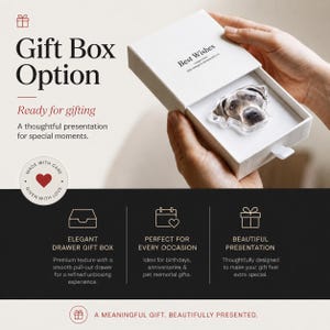 May include: A white rectangular sliding drawer gift box containing a clear acrylic dog portrait charm. The box lid features the text Best Wishes and the interior tray holds the dog charm. The packaging includes a white pull tab on the side.